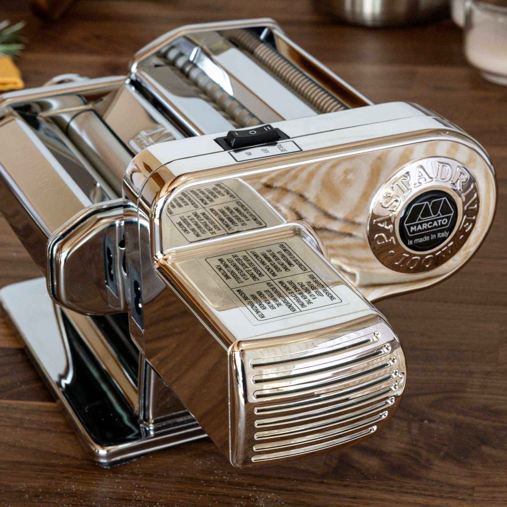 Pasta maker on a wooden surface with a brand logo visible