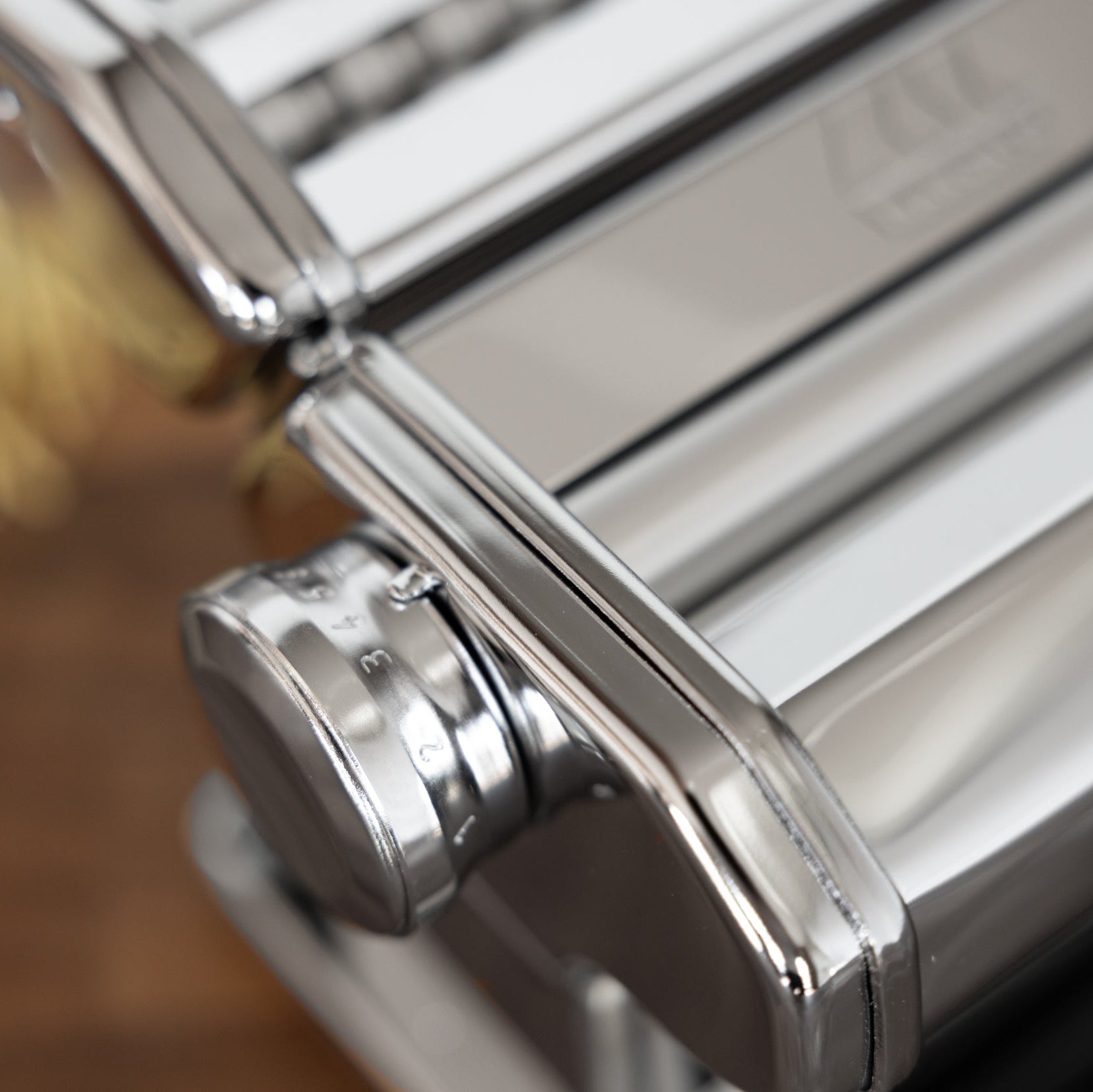 Close-up of an Atlas+ pasta maker with a blurred background