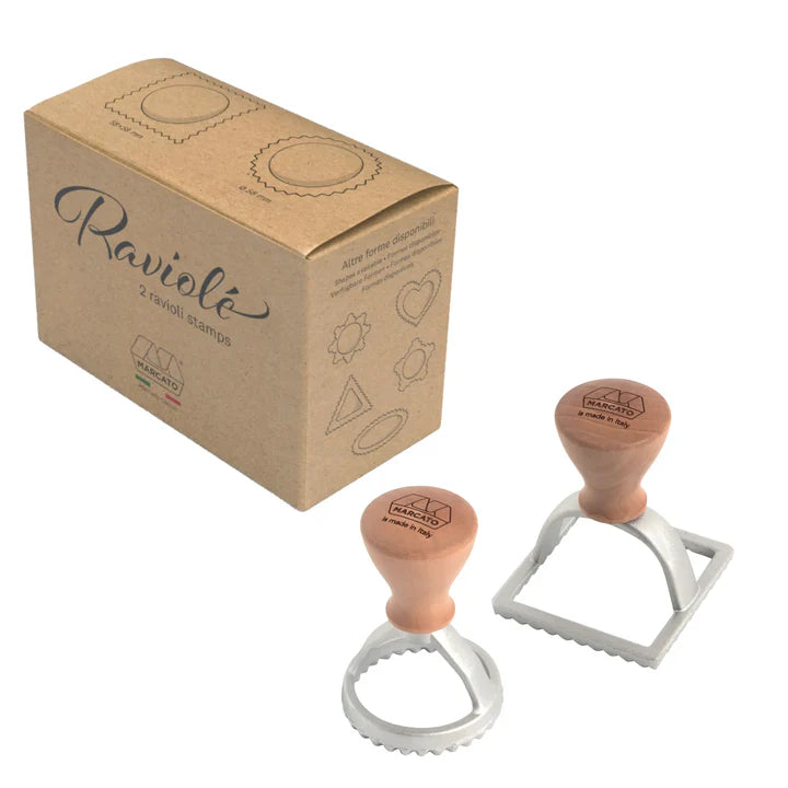 Two ravioli stamps with a cardboard box labeled 'Raviolé' on a white background.